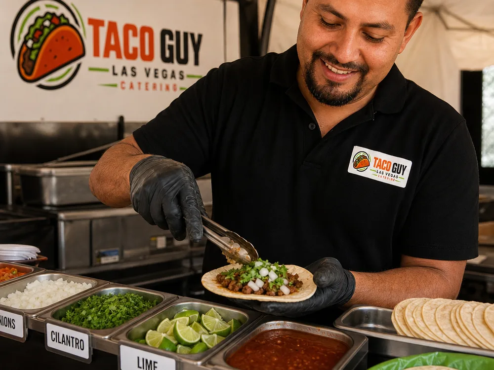 Clean taco catering station with labeled toppings, salsas, lime, cilantro, onions, and stacks of tortillas