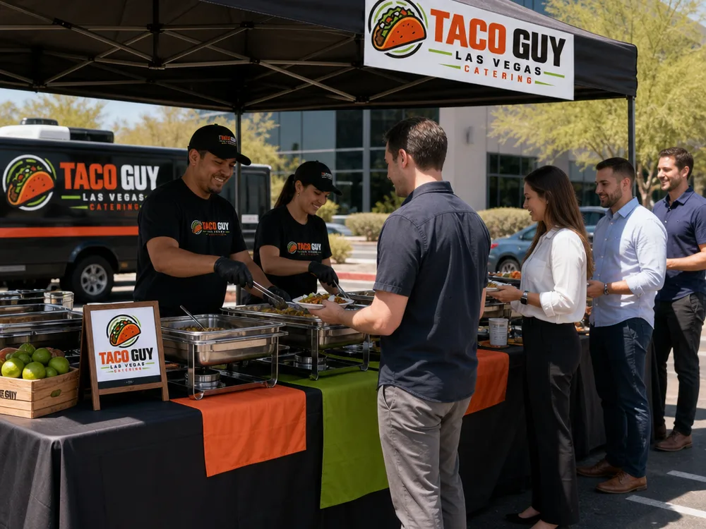 Staffed taco bar at a corporate lunch with a clear serving line and shaded setup
